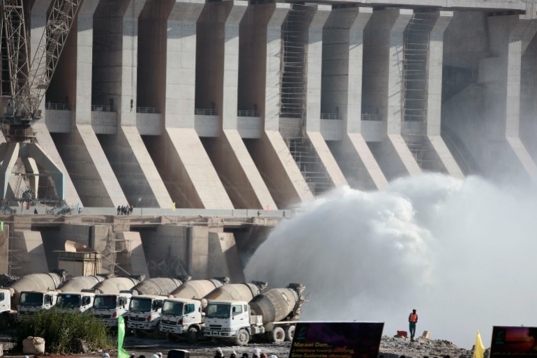 A member of a disaster management team secures the Merowe Dam in northern Sudan