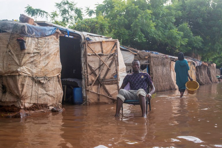 A man sits near his shelter on flooded street in Bamako, Mali September 22, 2024.REUTERS/Aboubacar Traore