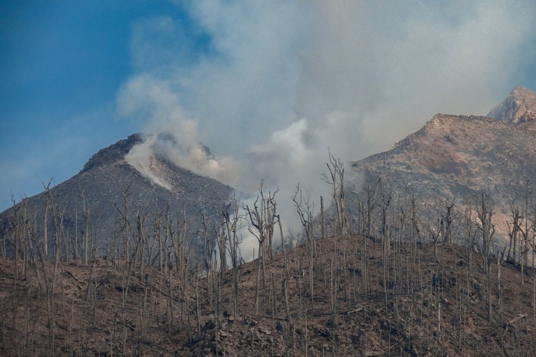 Lava periodically flows from the crater of Mount Lewotobi Laki-Laki a day after it erupted, as seen from Hokeng Jaya Village, East Flores, East Nusa Tenggara, on November 5, 2024. (Photo by ARNOLD WELIANTO / AFP)