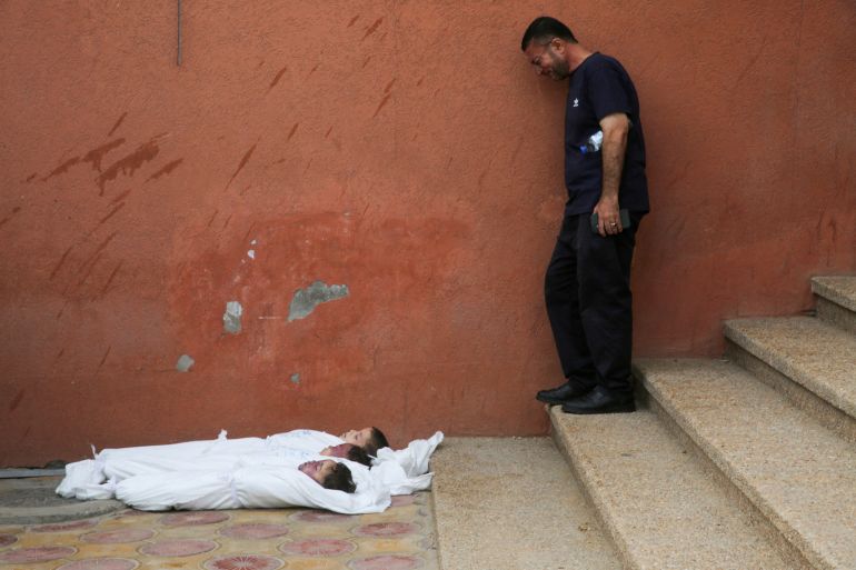 SENSITIVE MATERIAL. THIS IMAGE MAY OFFEND OR DISTURB A mourner reacts next to the bodies of Palestinian brothers, Yahia, Mussa, and Ibraheem Jadallah, who were killed along with their mother, Asya, in an overnight Israeli strike on their house, according to medics, at Nasser hospital in Khan Younis, in the southern Gaza Strip, July 10, 2025. REUTERS/Hatem Khaled TPX IMAGES OF THE DAY